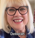 Smiling woman with blonde hair and glasses